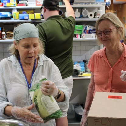 Volunteers preparing FLY lunches for local children