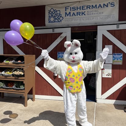 Easter Bunny greeting families during a Fisherman's Mark holiday meal distribution